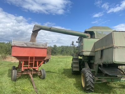 Transferring corn from the combine to wagon at the farm in Bloomer, WI