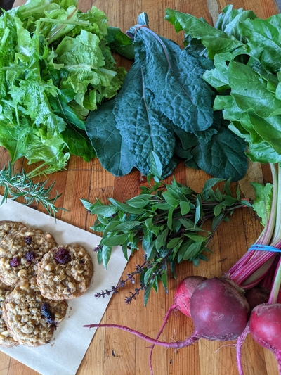 CSA share with lettuce, kale, basil, beets and cookies made with berries from the farm in Bloomer, WI