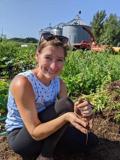 Vanessa with a snake in the vegetable garden in Bloomer, WI
